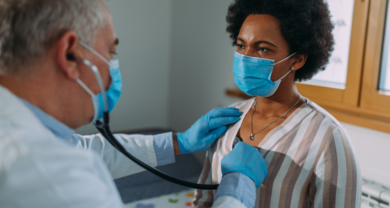 Doctor listening to lungs with stethoscope