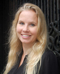 Stine Grodal standing by a black gate