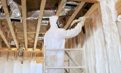 Worker Blowing Polyurethane Foam