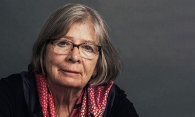 headshot of Barbara Ehrenreich sitting against gray background