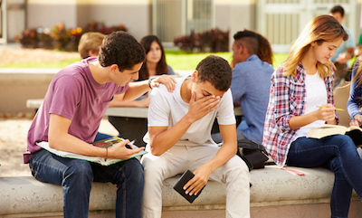 Male High School Student Comforting or Confronting Unhappy Male Friend