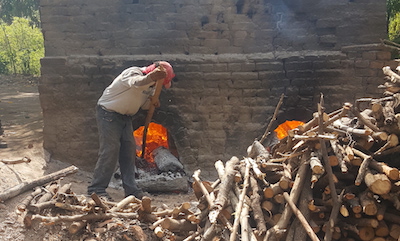 A man tends an oven at a brickworks in La Paz Centro, Nicaragua