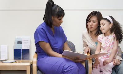 Nurse talking to mother and daughter