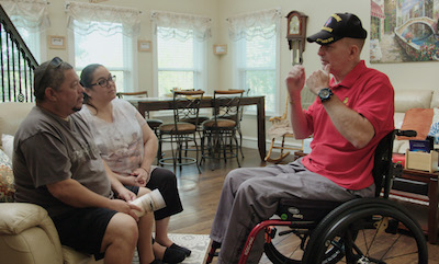 Willie and Sandra Reyes (left) talking to David Winnett, another veteran with Gulf War Illness. Courtesy of Netflix.