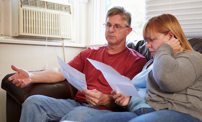 Worried couple looking at bills