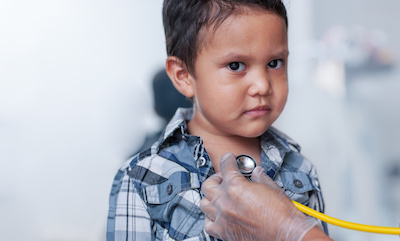 A young Hispanic boy having his heart listened to with a stethoscope