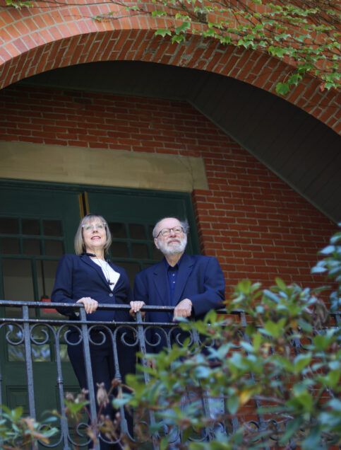 Sondra Crosby and George Annas stand on a balcony of Talbot Building