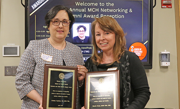 Krishna Upadhya and Cherrie Evans hold awards at the Maternal and Child Health Center of Excellence at SPH