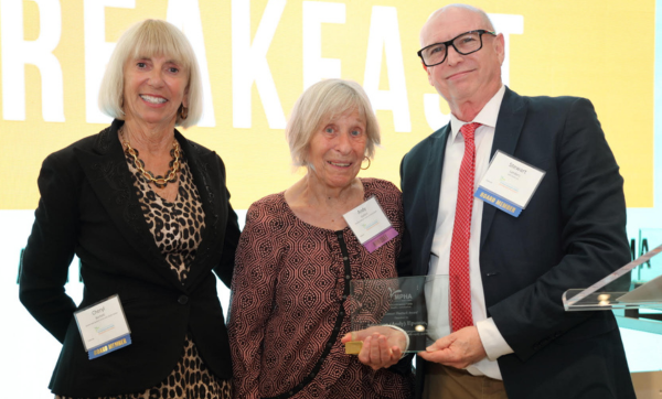 MPHA Board Members Cheryl Bartlett (left), CEO of New Bedford Community Health, and Stewart Landers (right), senior consultant at John Snow, Inc., present award to honoree Adrienne "Andy" Epstein (center).