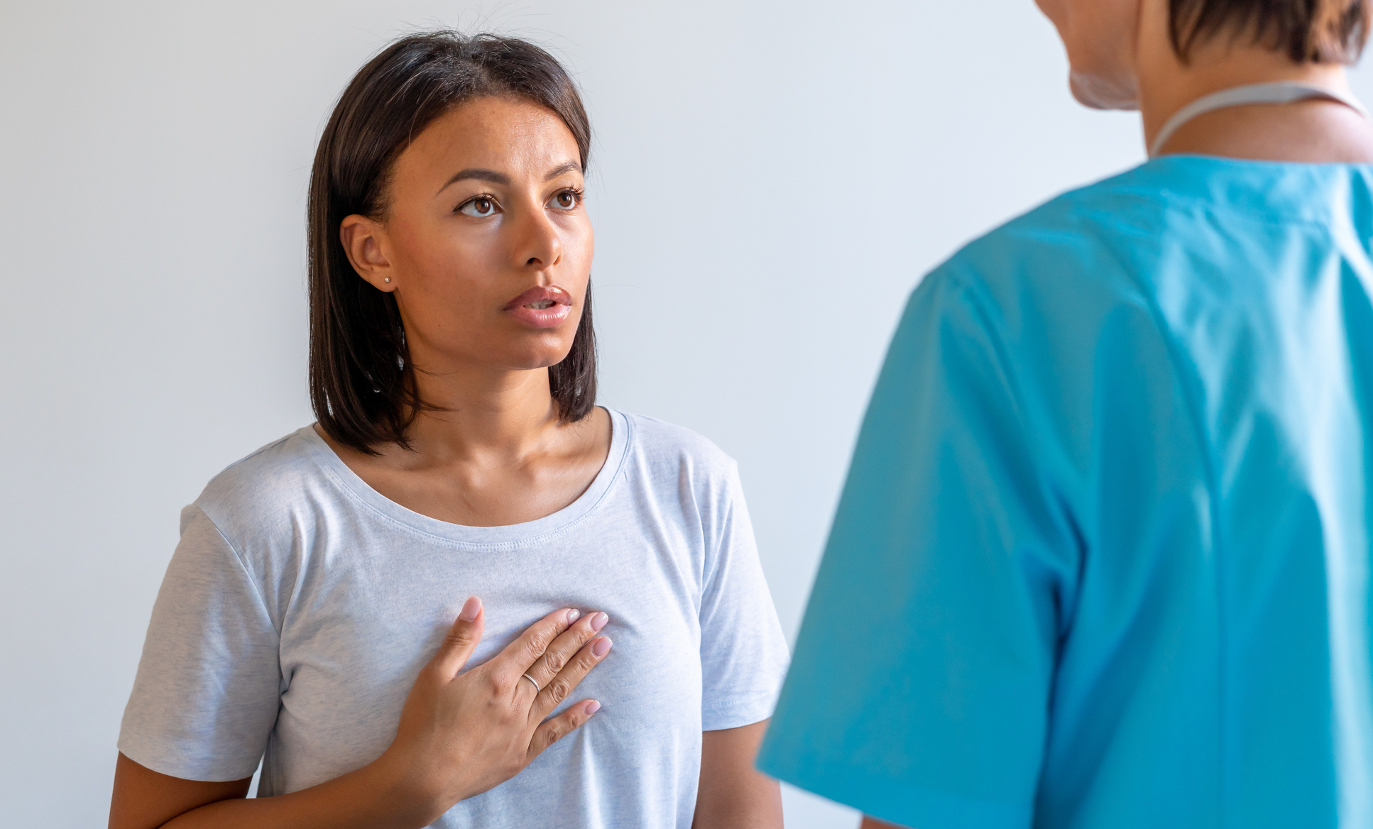 African american patient complaining about heartache in chest