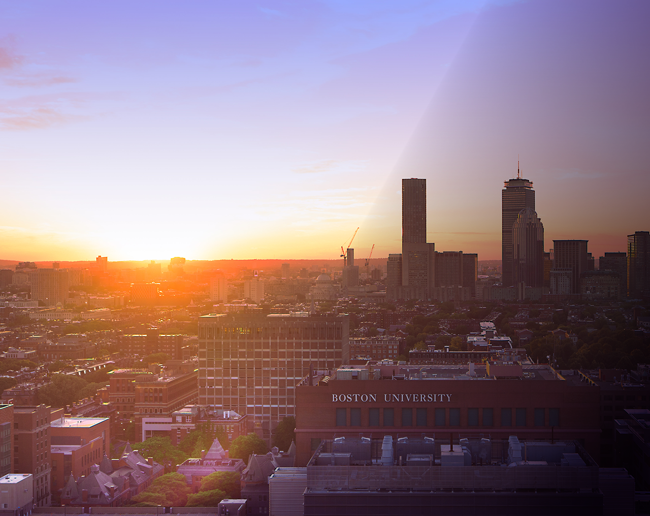 Boston skyline at sunset, BU campus visible in bottom right corner