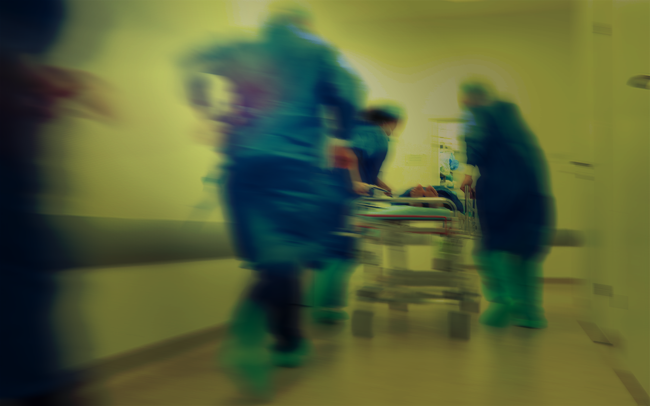 Doctors rushing patient into emergency surgery