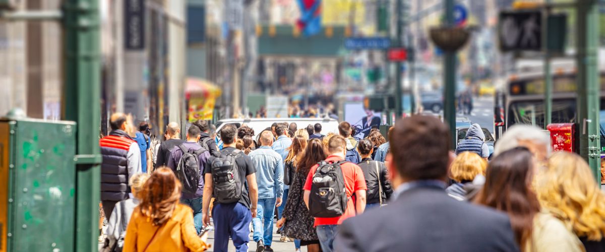 USA, New York, Manhattan streets. Skyscrapers and crowded streets, cars and busy people walking downtown in a spring sunny day