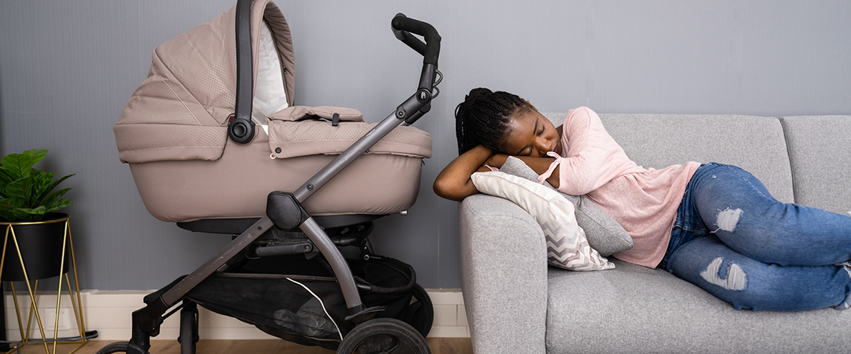 Sleepy-African-American-Woman-With-Newborn-600x362