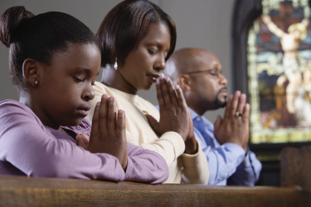 Family praying in church