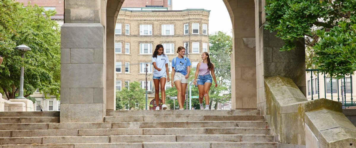 Three Boston University Summer Term students walking on campus - High School Student Application Information
