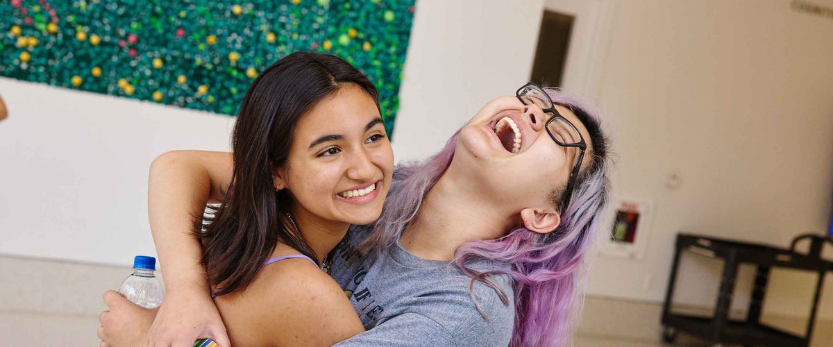 A Boston University student is embraced by her friend.