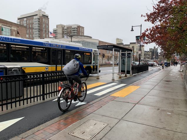 Biking on the Comm Ave cycletrack as an MBTA bus passes