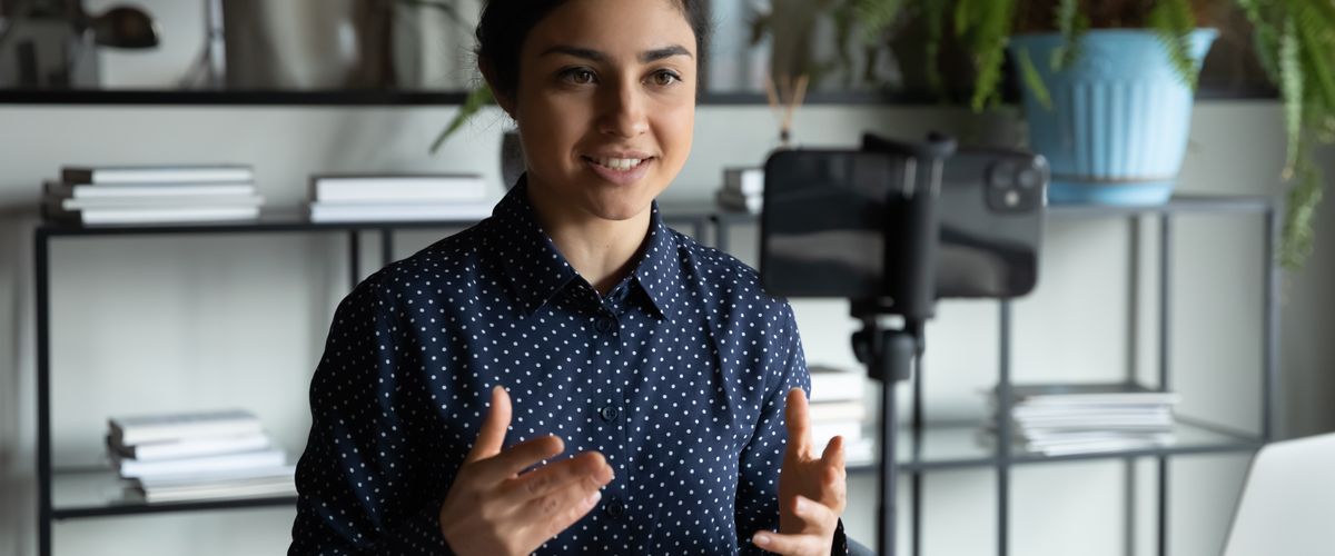 Person giving a presentation at a desk