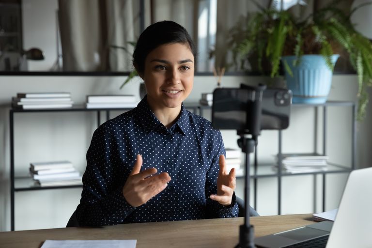 Person giving a presentation at a desk