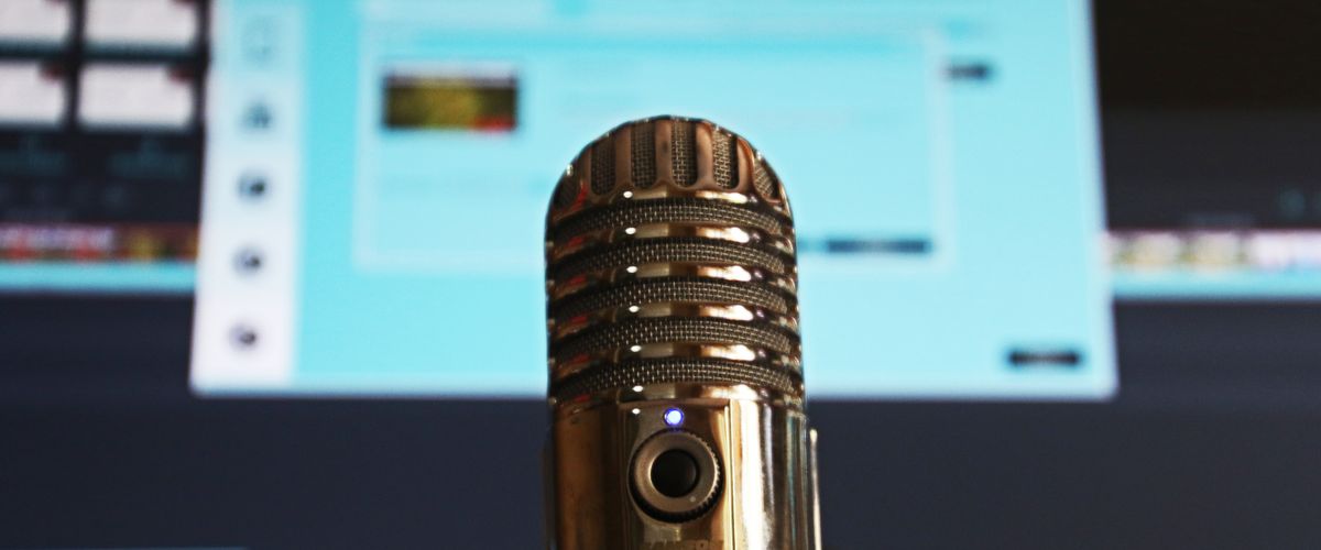 A microphone in front of a computer screen