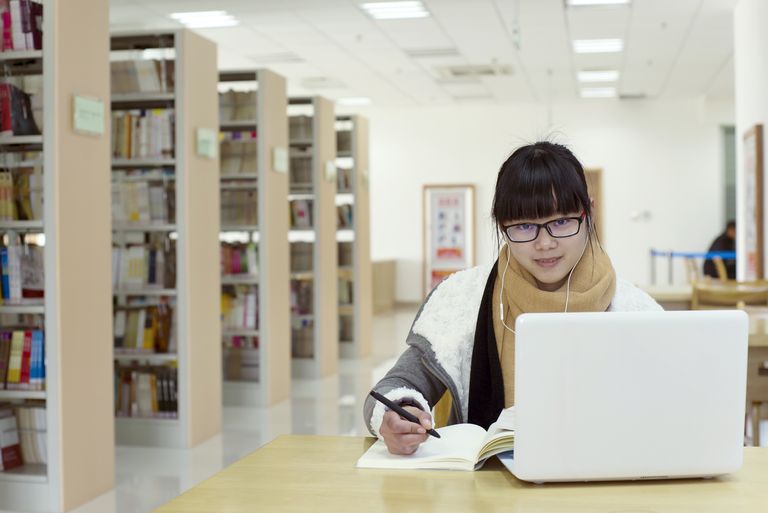 Person using a laptop in a library