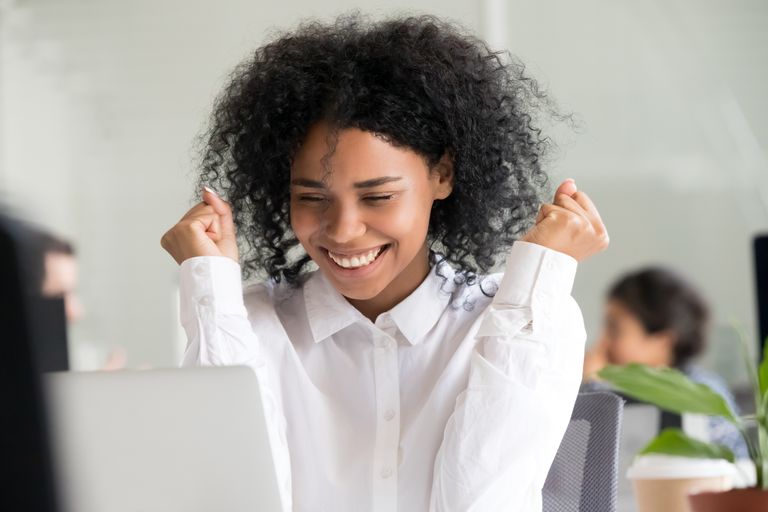 Person excitedly reacting to a laptop