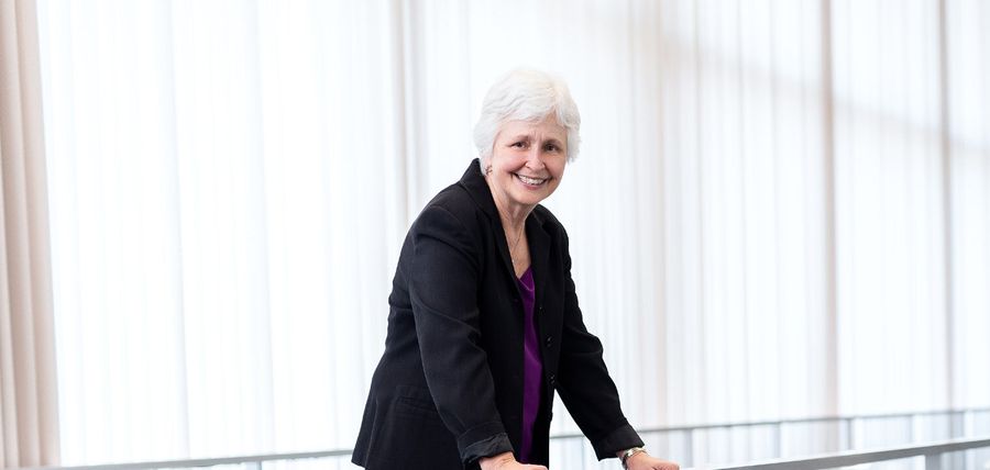 Jane Sigmon smiling leaning on a railing