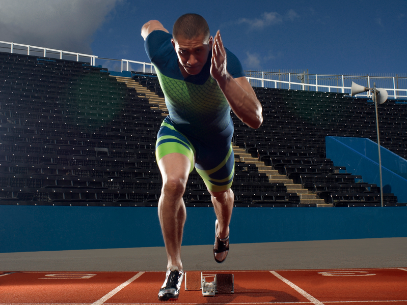 Man standing in running position ready to run towards camera