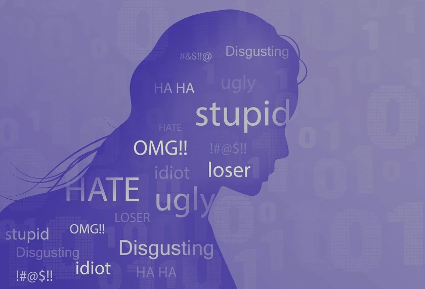 A silhouette of a person with insults like ‘stupid’ superimposed over them.