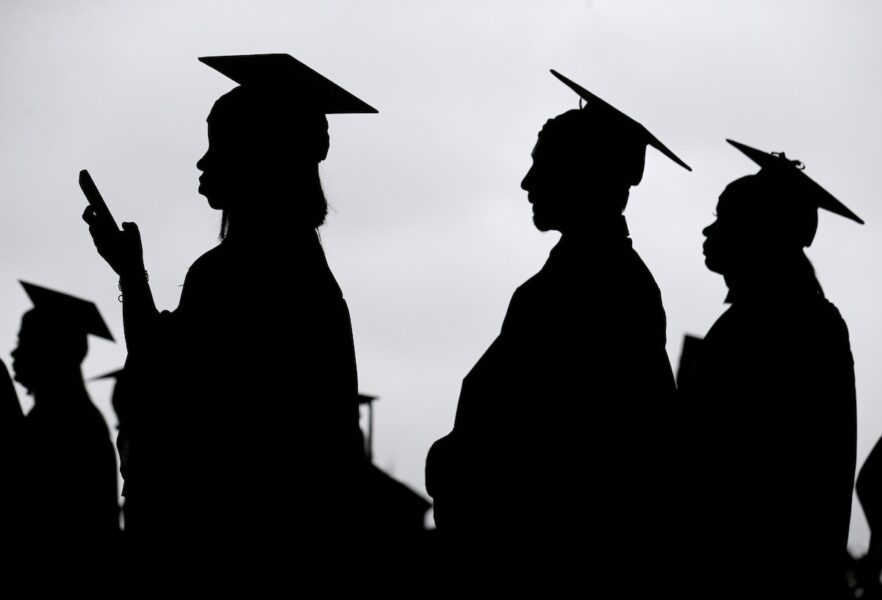 Silhouettes of a group of graduates.