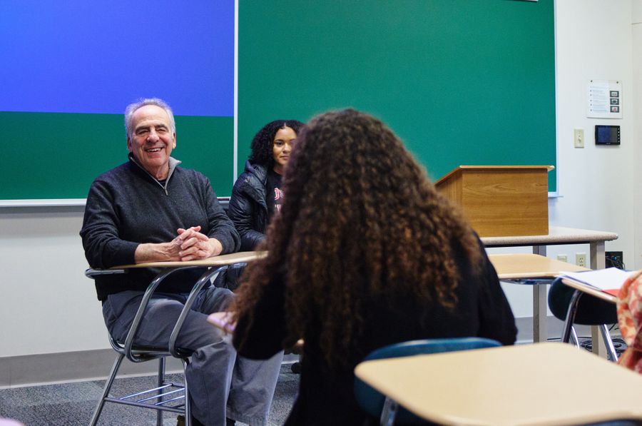 Shows a professor and two students