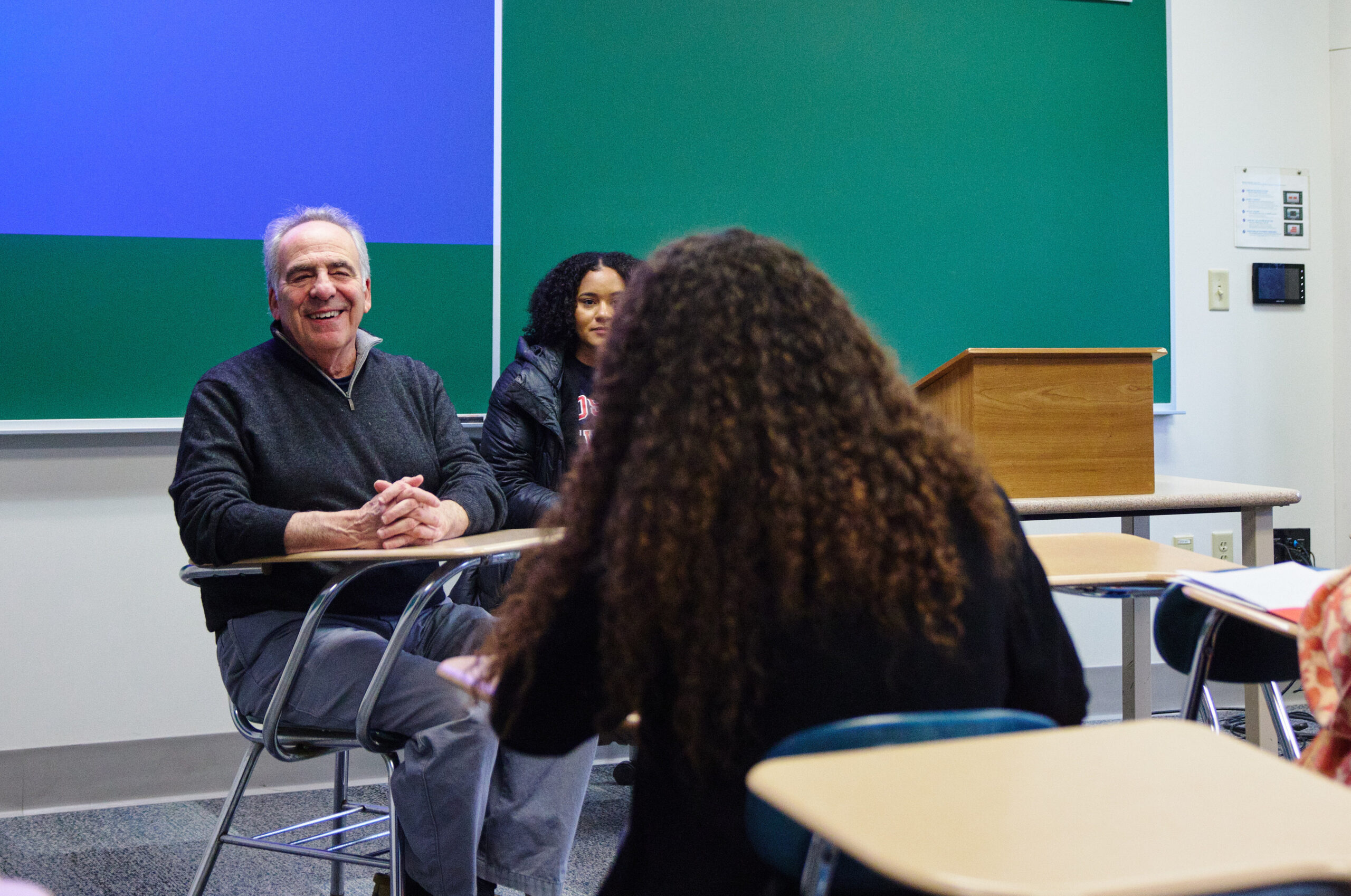 Shows a professor and two students