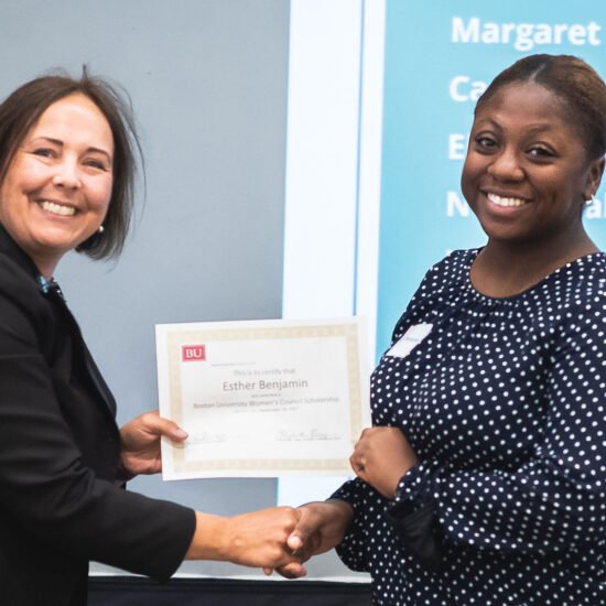 Elizabeth Flagg shaking hands with Esther Benjamin, awardee, as she receives a certificate.