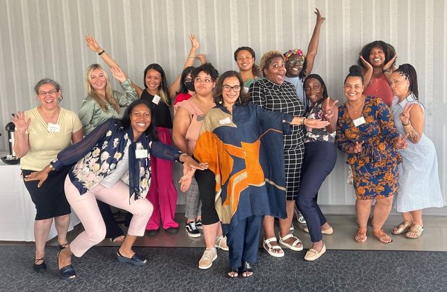 Group of joyful women in group photo poses.